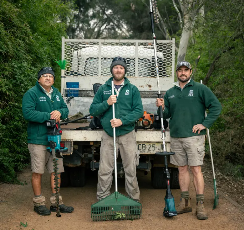 Three gardeners with equipment in front of van in Dubbo Zoo