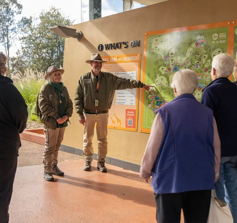 Group of guests being shown the large Taronga Western Plains map on the wall